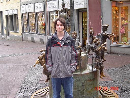 My son in Aachen in front of a statue.
